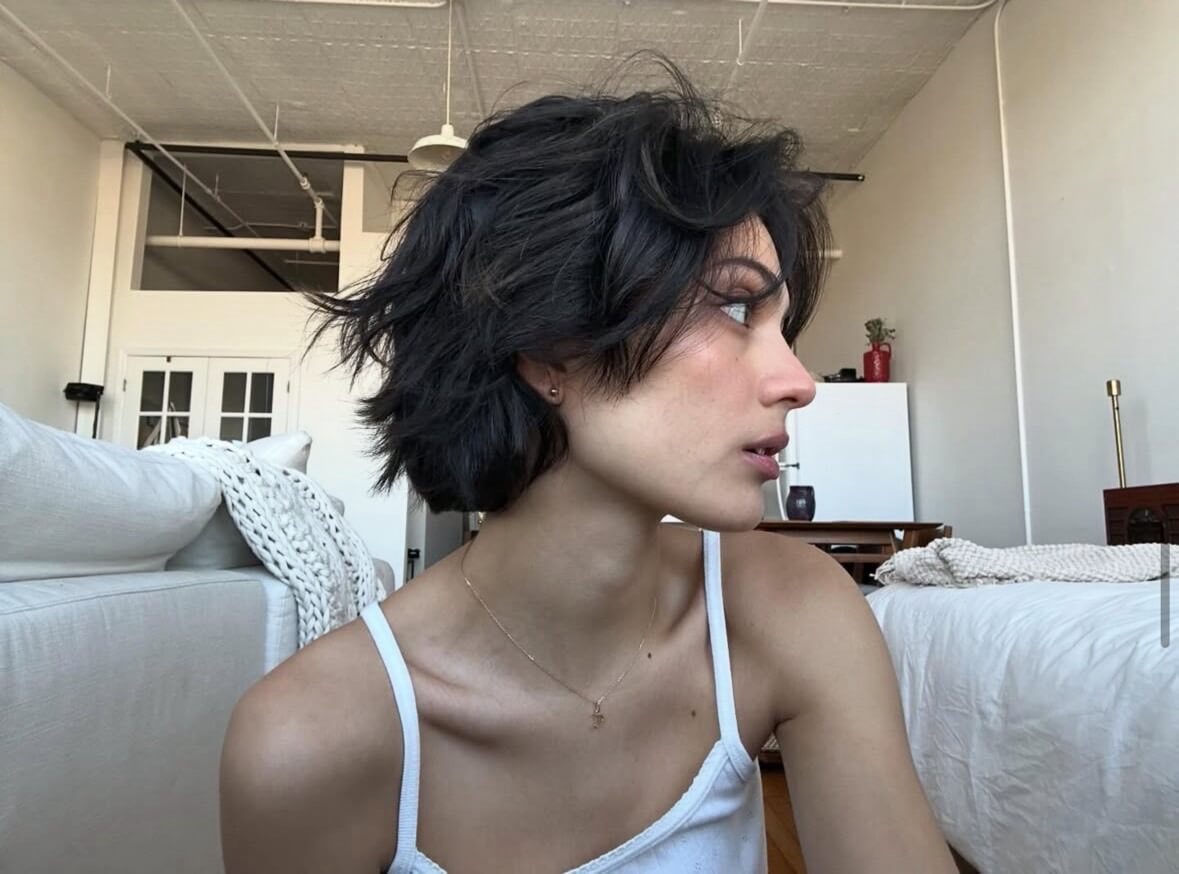 Mulher com corte de cabelo bixie, tendência de cabelo curto feminino 2026.