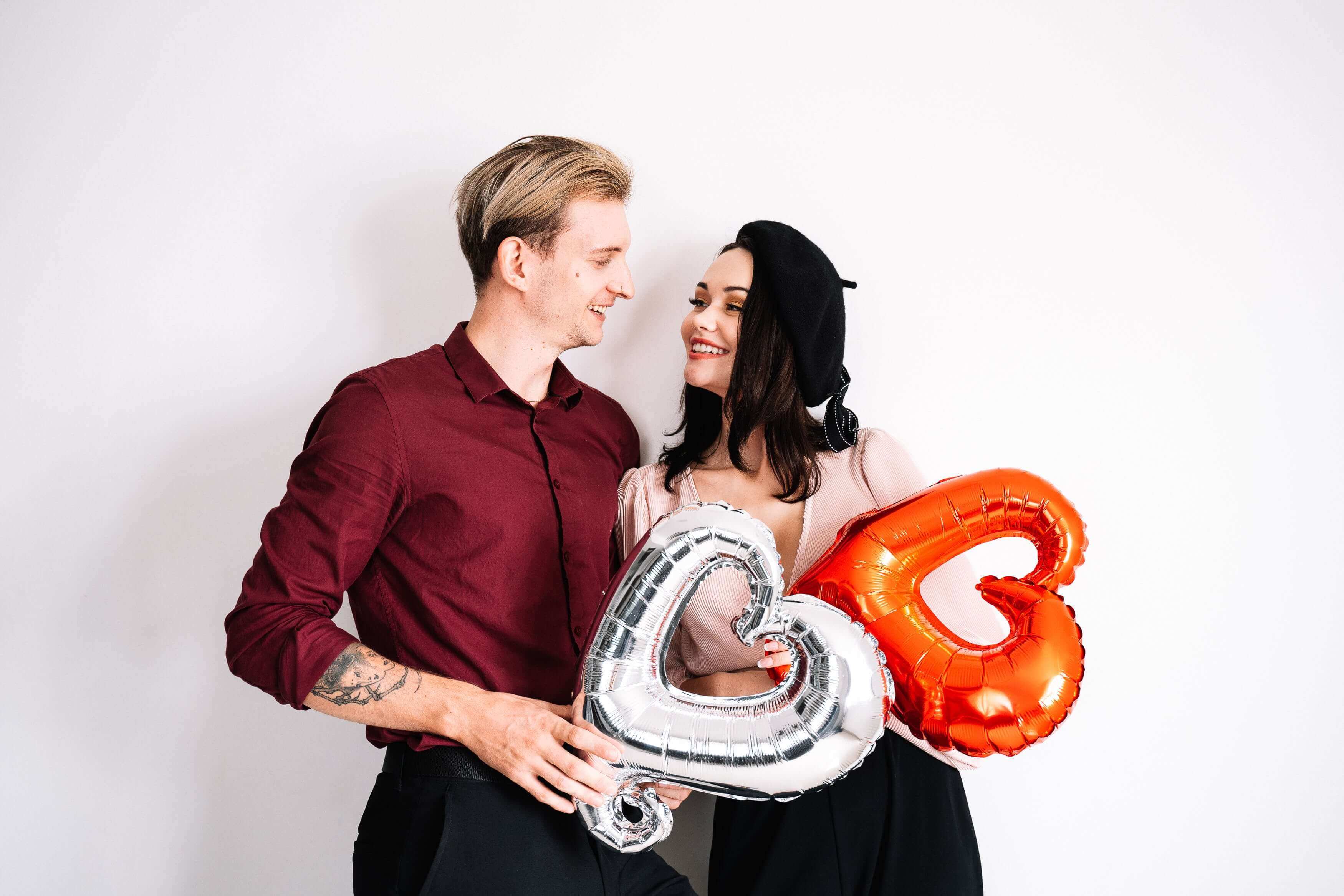 Valentine's Day Photo Idea: Couple with red and silver heart balloons