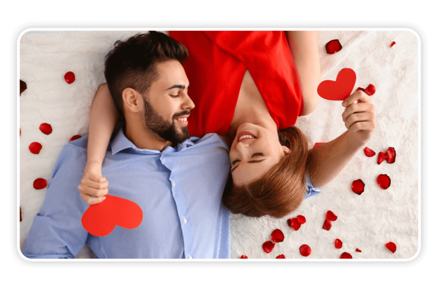 Valentine's Day Photo Idea: A Couple in bed with hearts and romantic Rose Petals