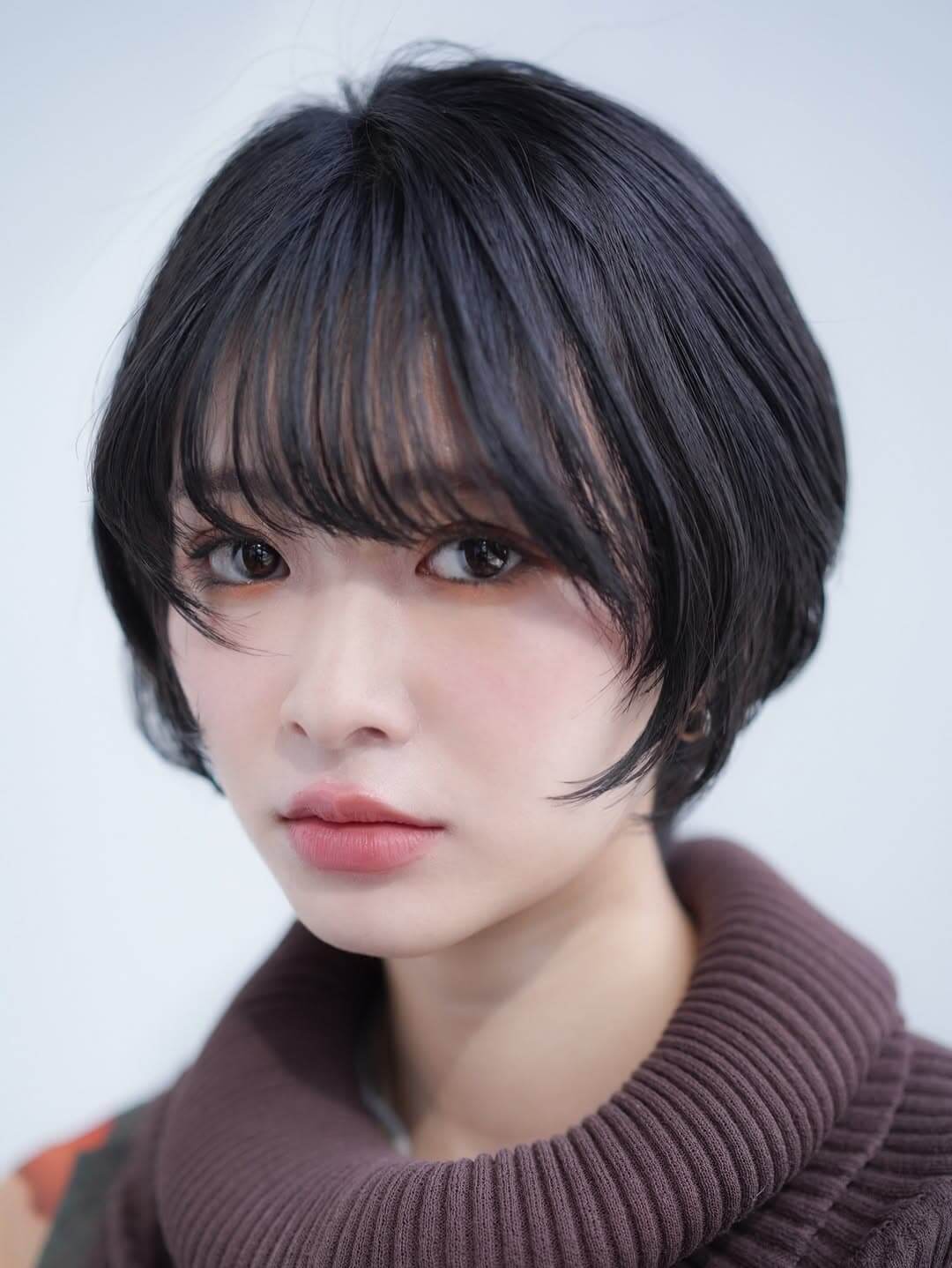 黒髪のひし形ショートヘアで垢抜けて見える女性