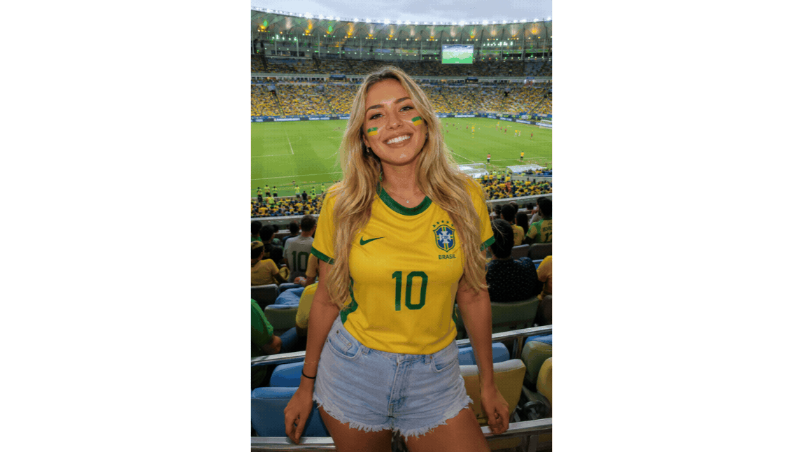 Soccer fan in a stadium wearing a yellow shirt before applying the digicam-style flash effect.