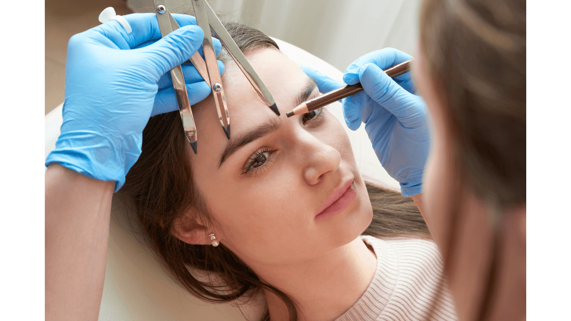 Responsible AI use in facial aesthetics Aesthetic practitioner using measuring tools to assess a client’s eyebrow and facial proportions.