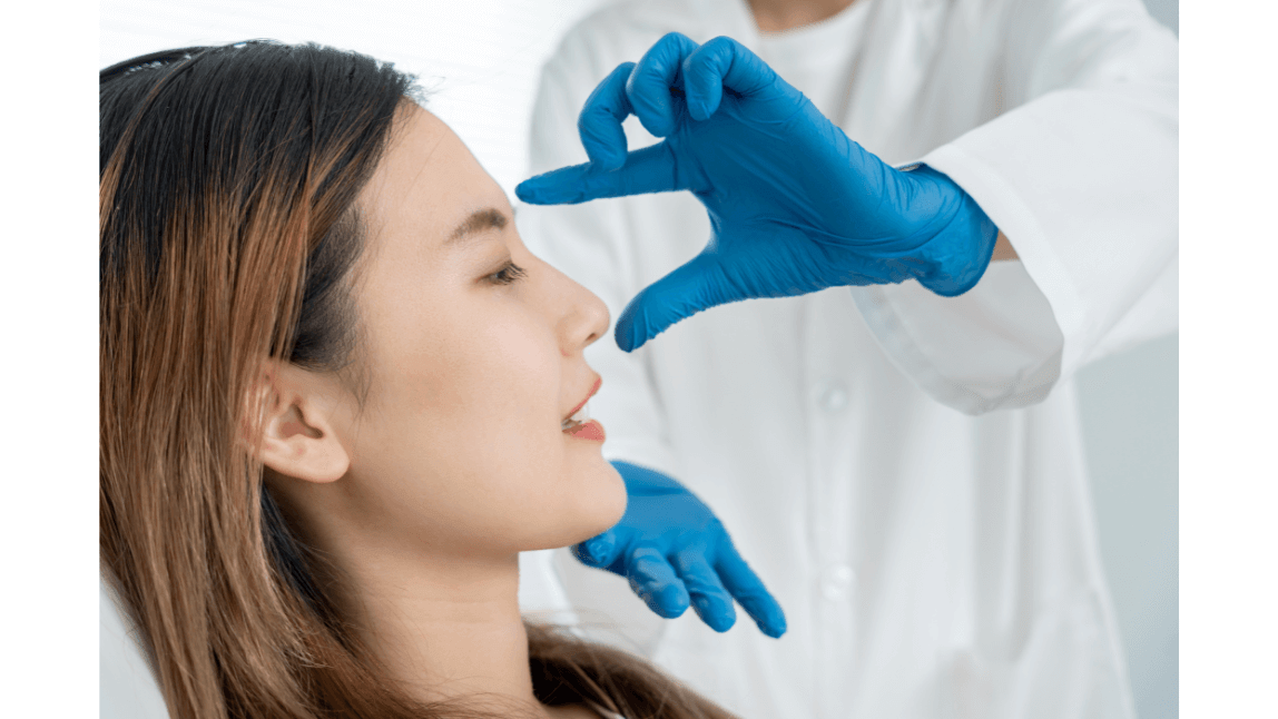 Natural facial enhancement consultation Aesthetic practitioner reviewing a client’s facial profile during a consultation.