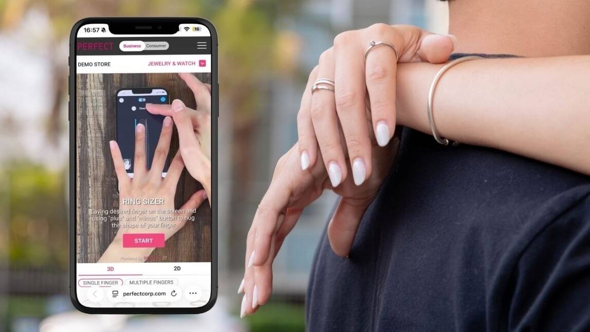 A mobile ring sizer by Perfect Corp beside hands wearing rings