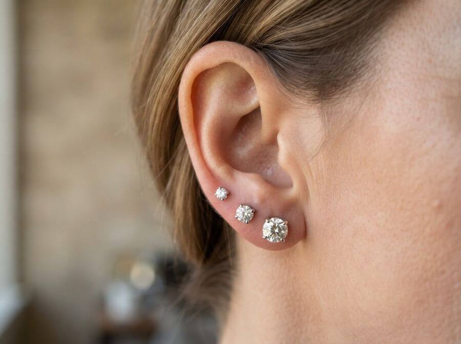 Diamond gradient ear stack with three studs climbing the lobe