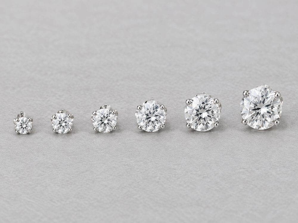 Diamond stud earrings from 3 mm to 8 mm lined up by size