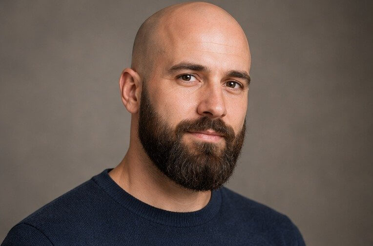 Bald man with a full, well groomed dark brown beard