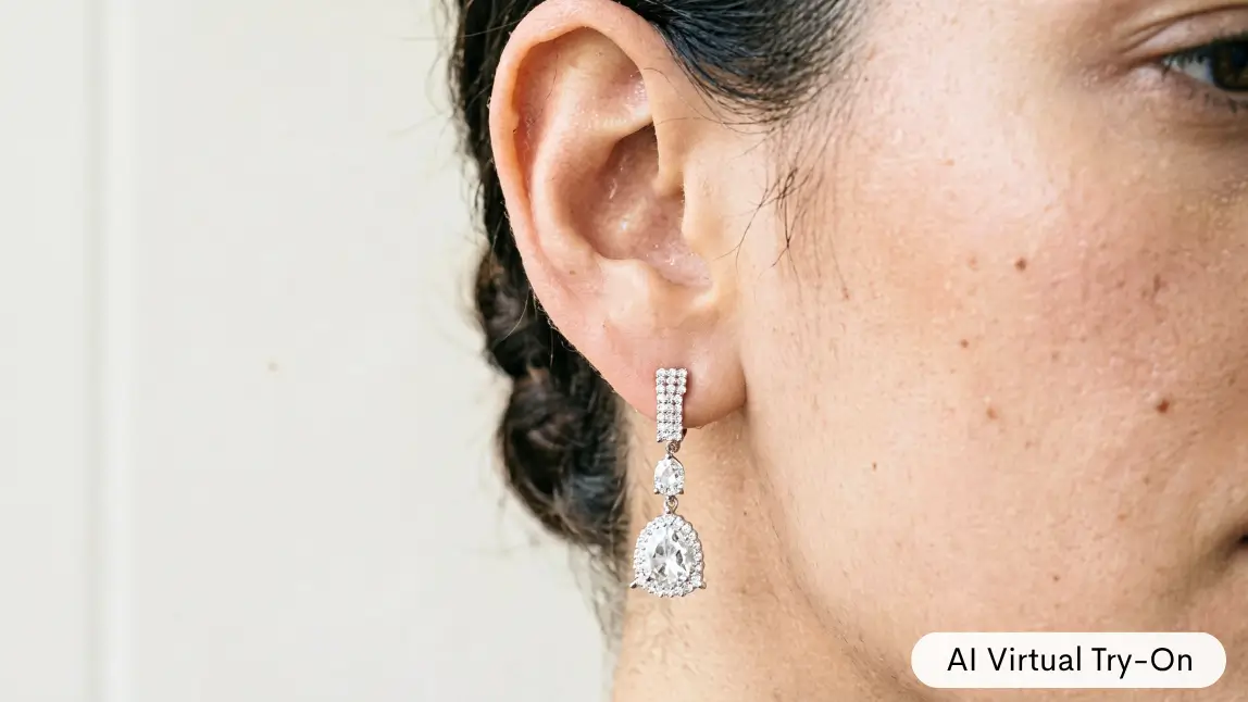 Close up of a woman's ear wearing diamond drop earrings