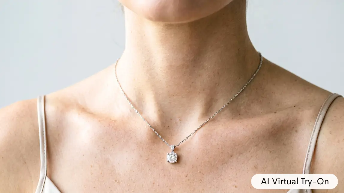Close up of a woman's neck and collarbone wearing a diamond pendant necklace