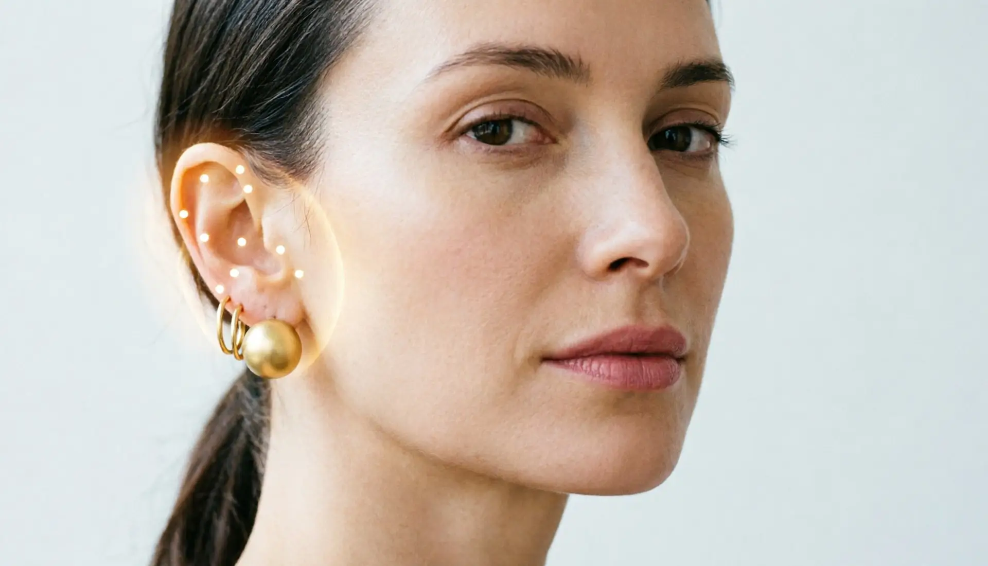 Pixel coordinate overlay showing precise ear piercing placement points on a real ear photo