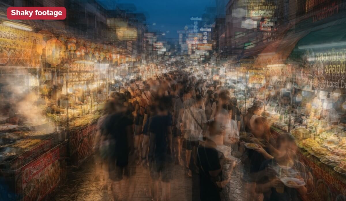 A handheld clip of a night market, shown as an illustrative shaky frame with blurred double edges