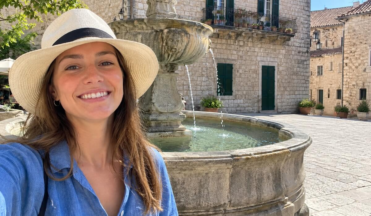 Same selfie by the fountain after the five tourists were removed, leaving an empty cobblestone square